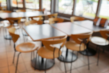 Blurred view of cafeteria with tables and chairs