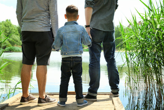 Gay couple with son on a pier