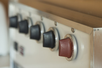 Retro stove top blurred background with cooking concept old dials and tempurature adjustment.