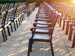 empty chairs in a rows outdoor before concert or show, toned, sunlight