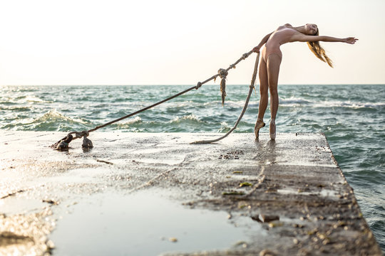 Ballerina posing on seafront