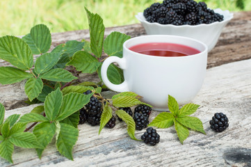Fototapeta na wymiar Cup of tea and blackberry plate