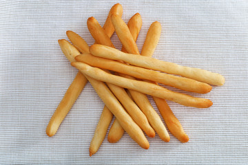 Grissini top view on textural textile background.