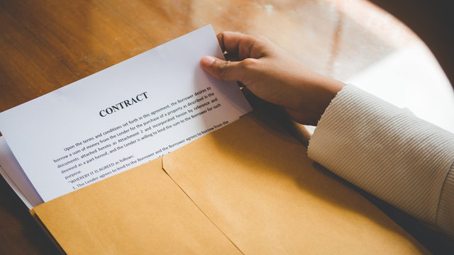 Women are opening an envelope document about signing a contract in business and sign contract concept,vintage style .