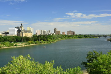 Fototapeta na wymiar The skyline of Saskatoon Saskatchewan with the South Saskatchewan river running through it.