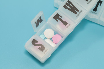 Daily Pill Box table on blue background