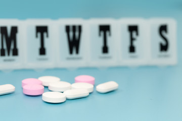 Daily Pill Box table on blue background