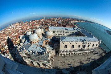 Venice, Italy. The view of the city from height of bird's flight. In the center of the Cathedral, pedestrians. On the right side of the sea, and on the left the roofs of houses.