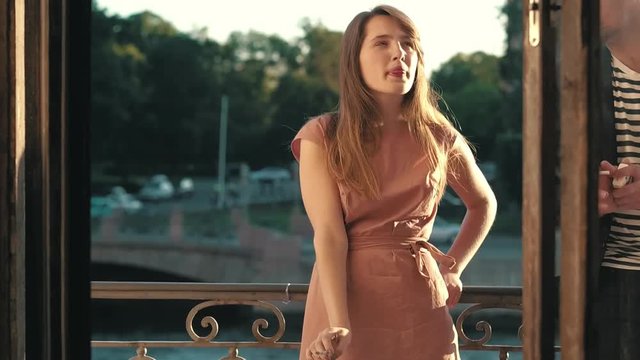 Young woman smoking a cigarette. Man and a woman smoking cigarettes