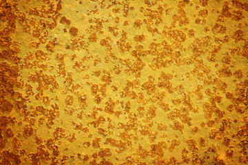 Grunge textured stone surface painted to gold color. Golden grunge surface background