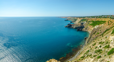 Fototapeta na wymiar Fiolent Cape Crimea Black Sea. Blue azure seaside with corals sand and stones