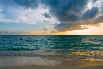 Naklejka na ściany i meble Landscape of beautiful sunset in Maldives island sandy beach with colorful sky over wavy sea