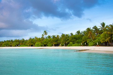 Fototapeta na wymiar Landscape of beautiful sunset in Maldives island sandy beach with colorful sky over wavy sea