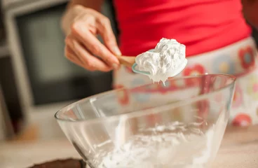 Rolgordijnen Adult woman whipping cream with whisk in glass bowl © guruXOX