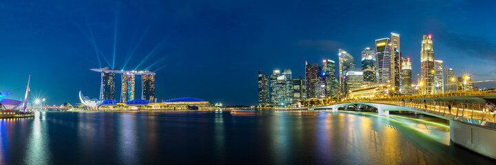 Fototapeta na wymiar Panoramic view of Singapore business district skyline during laser show in the evening.