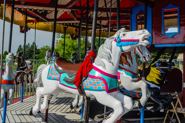 Fototapeta na wymiar Horizontal close 3/4 view of a white horse in a Vintage Carousel