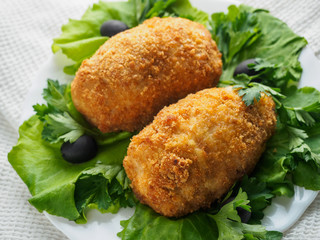 Beef cutlets with greens and vegetables on the plate