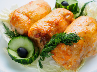 Roll chicken with greens and vegetables on the plate