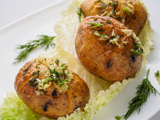 baked potatoes with greens and spices on the plate