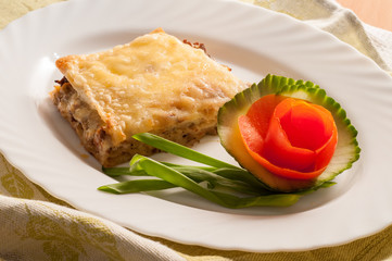 lasagne with meat and tomato on the plate