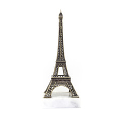 Paris Eiffel tower miniature on the marble stand isolated on white background
