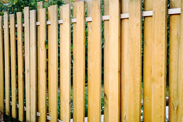 Fragment of a wooden brown modern fence close-up. Wood texture. Modern Style Design wooden Fence Ideas.