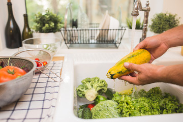 Man washes vegetables before eating