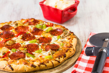 Pepperoni and Vegetable Pizza with Cheese and Cutter