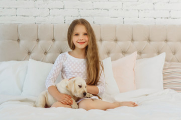 Little girl with labrador puppy