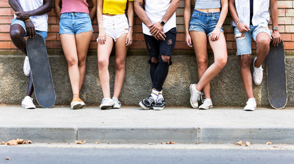 Group of young hipster friends posing in an urban area.