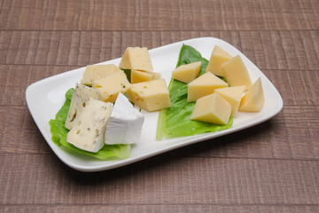 Plate with three kinds of cheese. Cheeseboard.