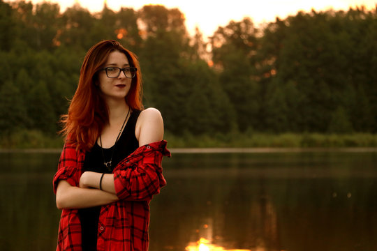 Young pretty woman in sunlight is smiling and touching herself