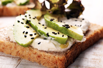 Sandwich with avocado and sesame - healthy breakfast concept