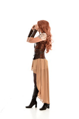 full length portrait of a red haired lady, wearing a steampunk inspired outfit, isolated  on white background.