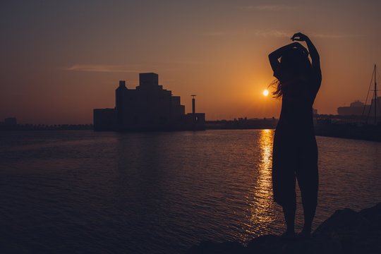 Silhouette of a woman at sunrise