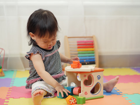 baby girl playing toy at home