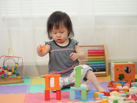 baby girl playing toy at home