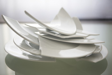 broken white plates on glass table