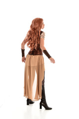 full length portrait of a red haired lady, wearing a steampunk inspired outfit, isolated  on white background.