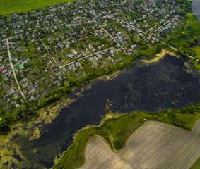 Beautiful panorama of countryside with a beautiful lake at sunset. Aerial view of scenic landscape in Ukraine, Central Europe.