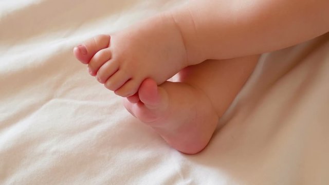 Two little feet a newborn baby On a white background. Full HD 1080p