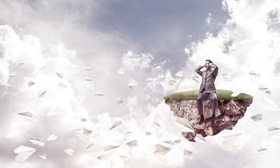 Obraz premium Young man in sky dont want to hear anything and paper planes fly