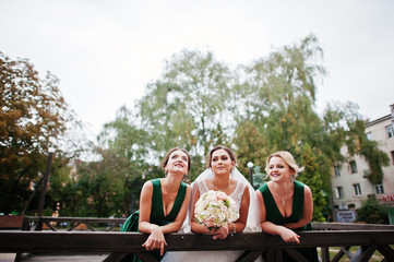 Fabulous bride walking, posing and having fun with her bridesmaids in the downtown on a wedding day.