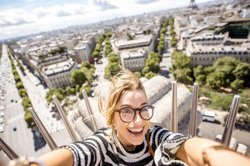 Young happy woman tourist making selfie portrait with great cityscape view on Paris