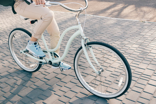 Cropped image of a woman riding a bicycle