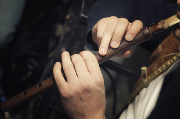 the musician plays on the traditional Middle Eastern and Asian brass musical instrument duduk © vigenmnoyan