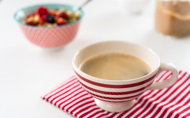 Healthy breakfast - cup of coffee, muesli and fresh berries on white wooden background, top view, health and diet concept