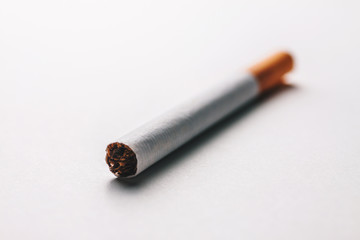 Close-up of a cigarette on a blank surface