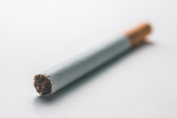 Close-up of a cigarette on a blank surface