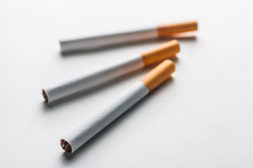 Close-up of a cigarette on a blank surface